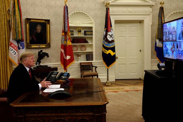 FILE PHOTO: U.S. President Donald Trump holds a video call with U.S. military service members in the Oval Office on Christmas morning in Washington