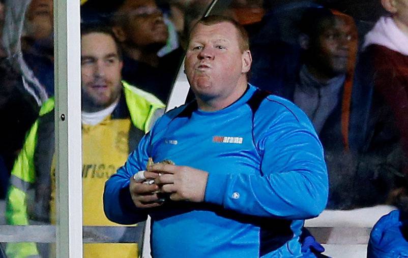 FILE PHOTO:  Sutton United's substitute Wayne Shaw eats a pie during the match