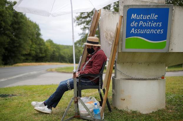 Martial Leotard, General Director of Les Ducs de Richelieu society, is seen chained in front of the Mutuelle de Poitiers Assurance, in Liguge