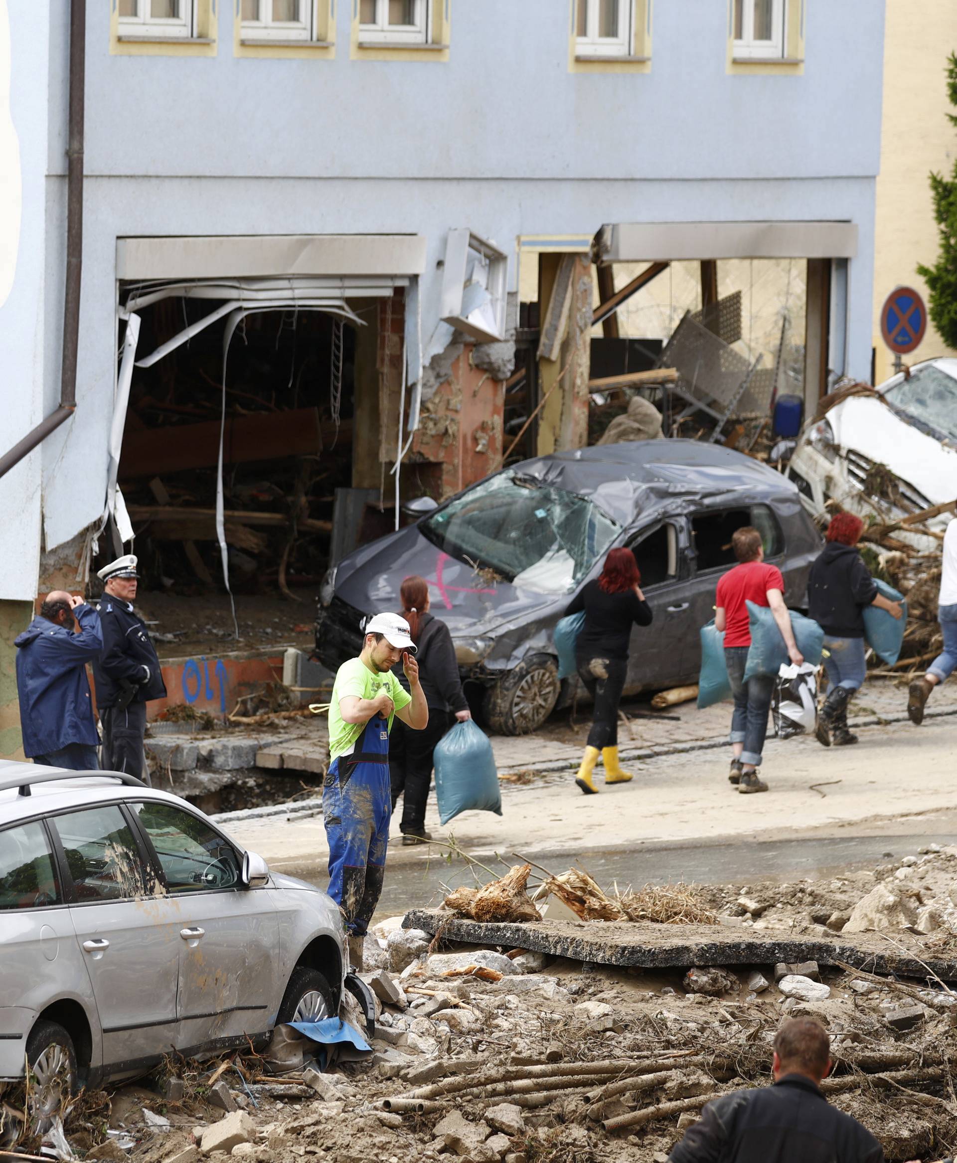 People start to clear-up debris following floods in the town of Braunsbach in Baden-Wuerttemberg