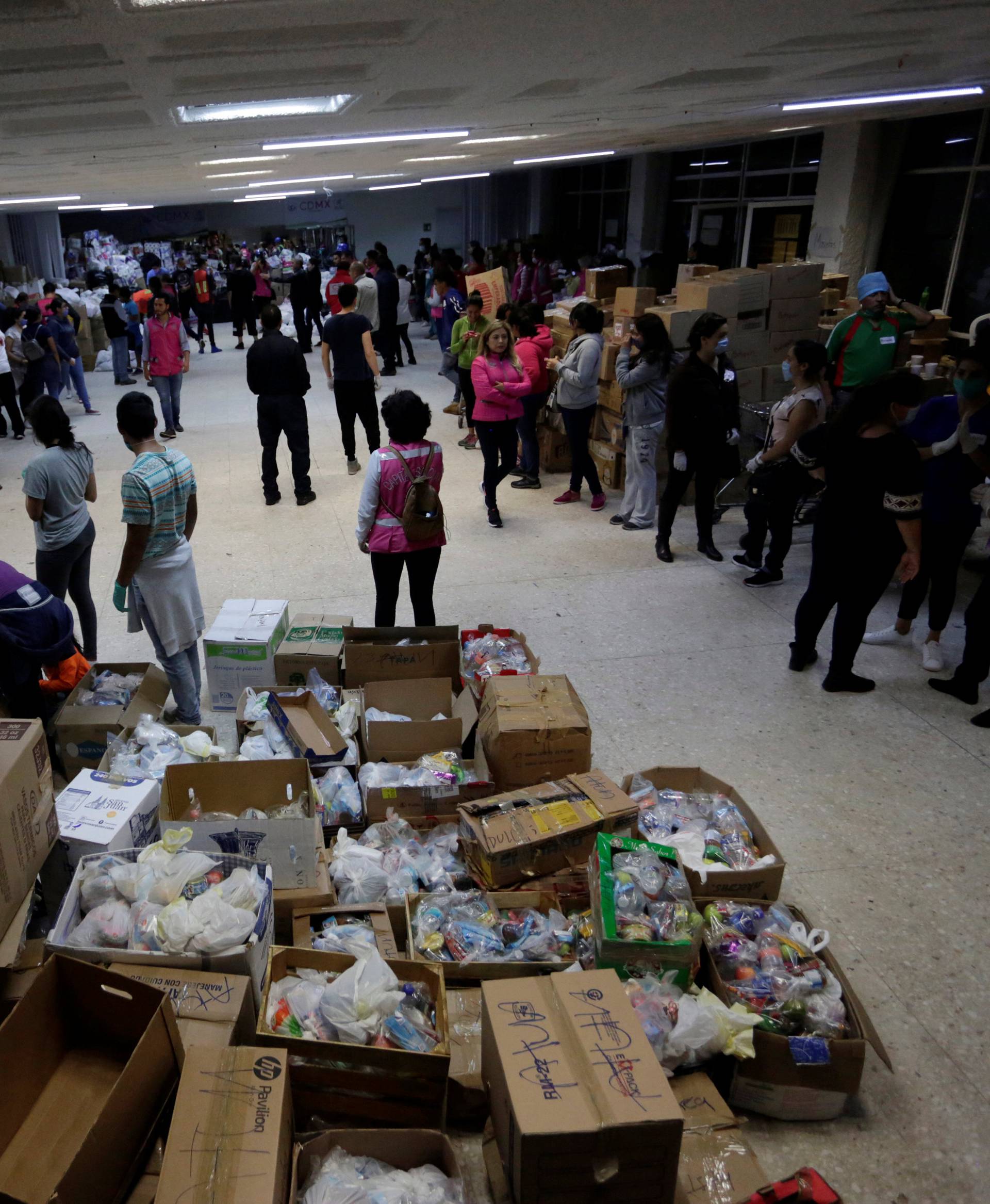 People stand in a shelter and collection center after an earthquake in Mexico City