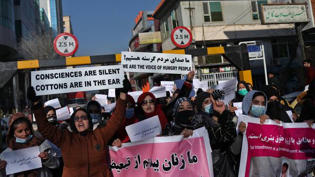 Afghan women shout slogans during a rally to protest against what the protesters say is Taliban restrictions on women, in Kabul