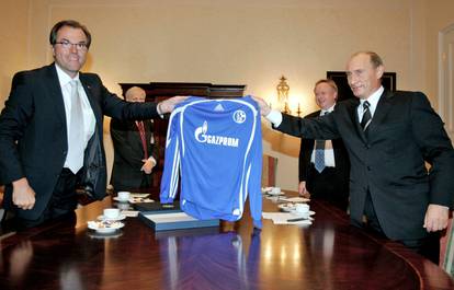 FILE PHOTO: Toennies of German soccer club Schalke 04 and Russian President Putin hold jersey with Gazprom logo in Dresden