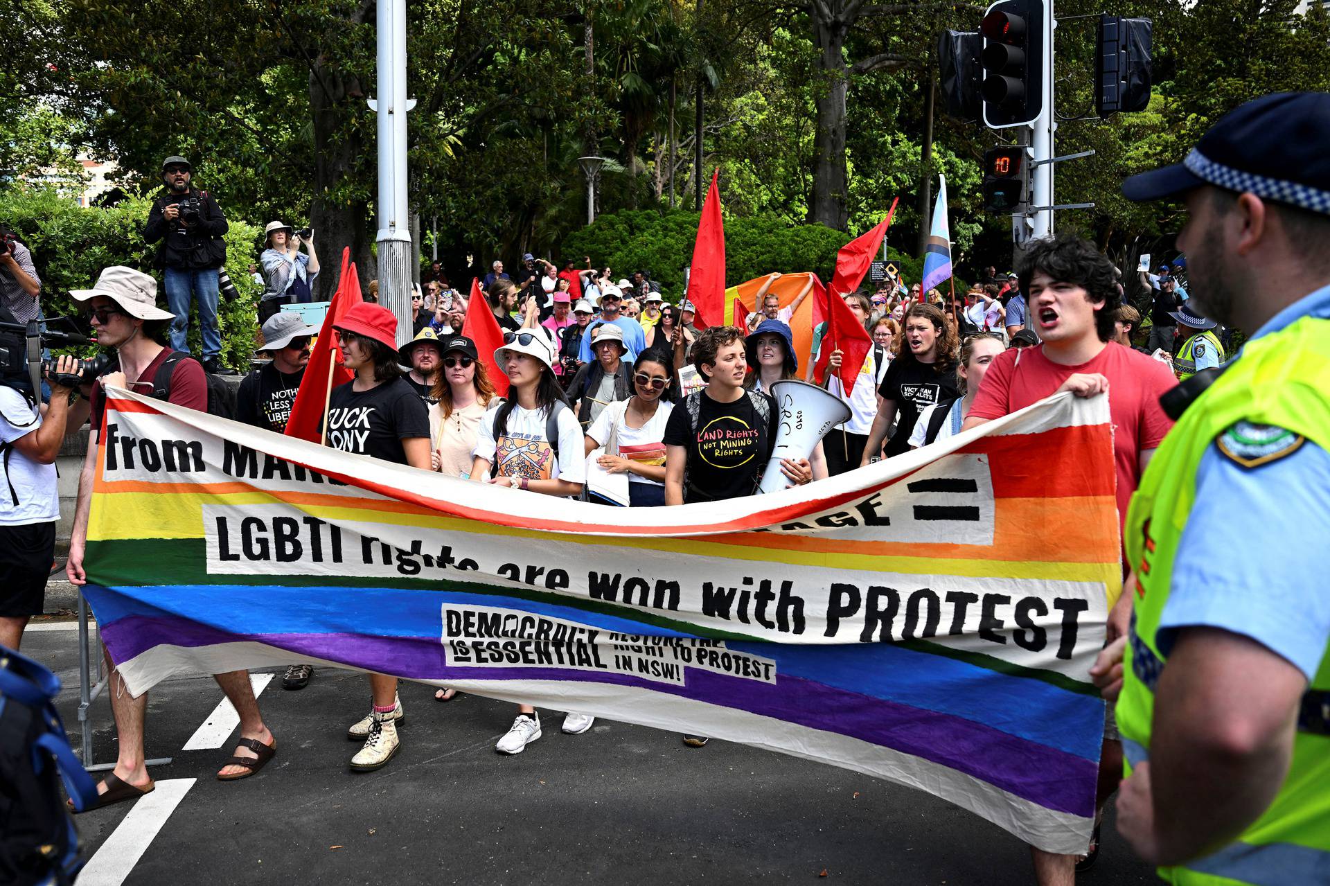 People rally during a protest outside the Pontifical Funeral Mass for Cardinal Pell at St Mary's Cathedral in Sydney