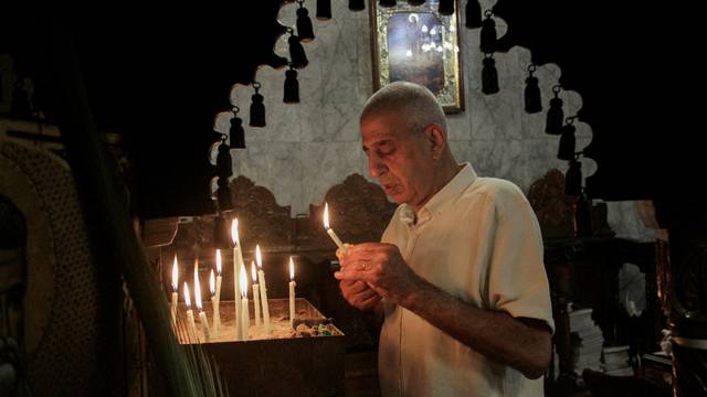 Palestinian Christians hold an Orthodox Easter mass at the Greek Orthodox Saint Porphyrius Church, in Gaza City