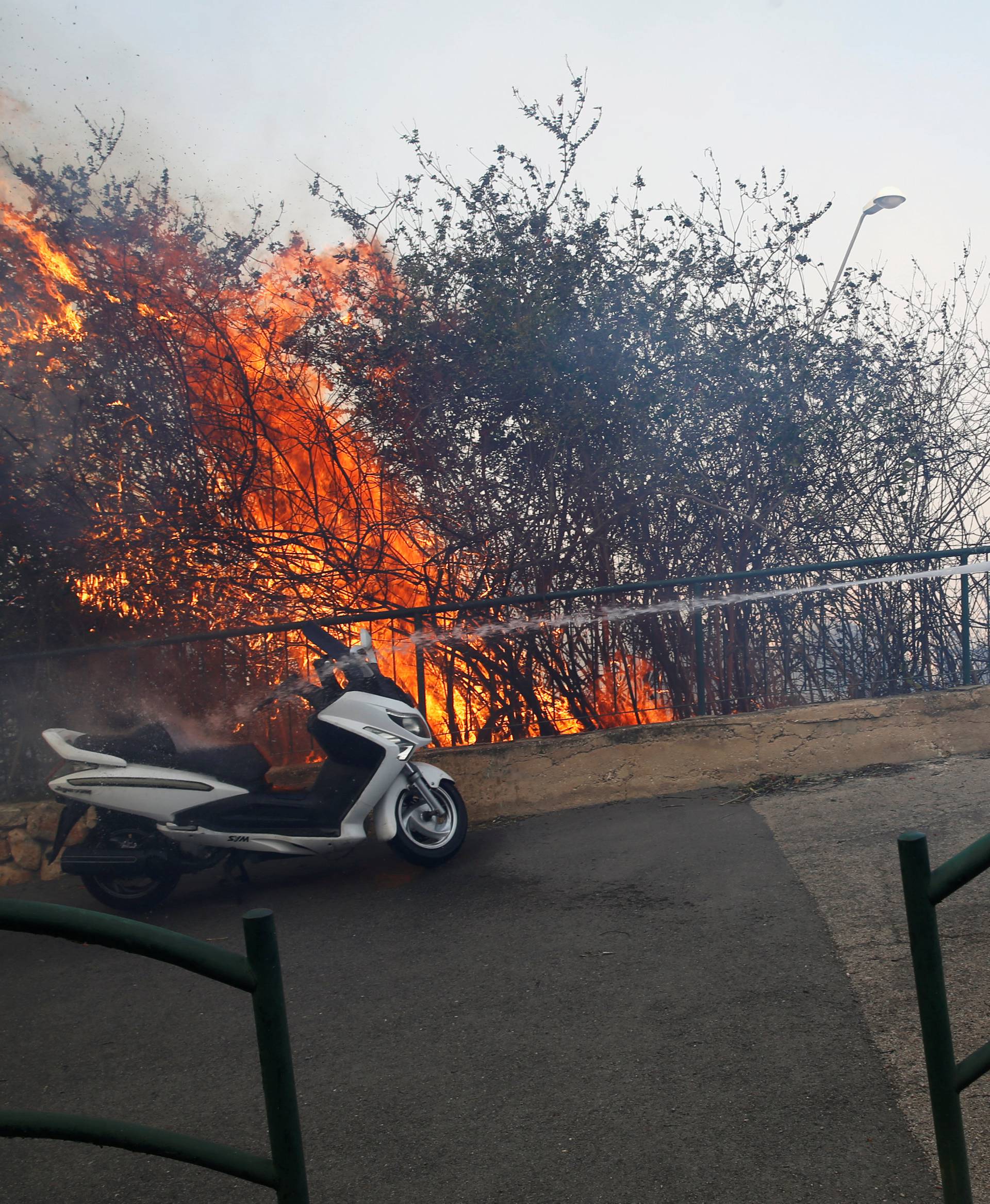 A firefighter extinguishes a wildfire in the northern city of Haifa, Israel 