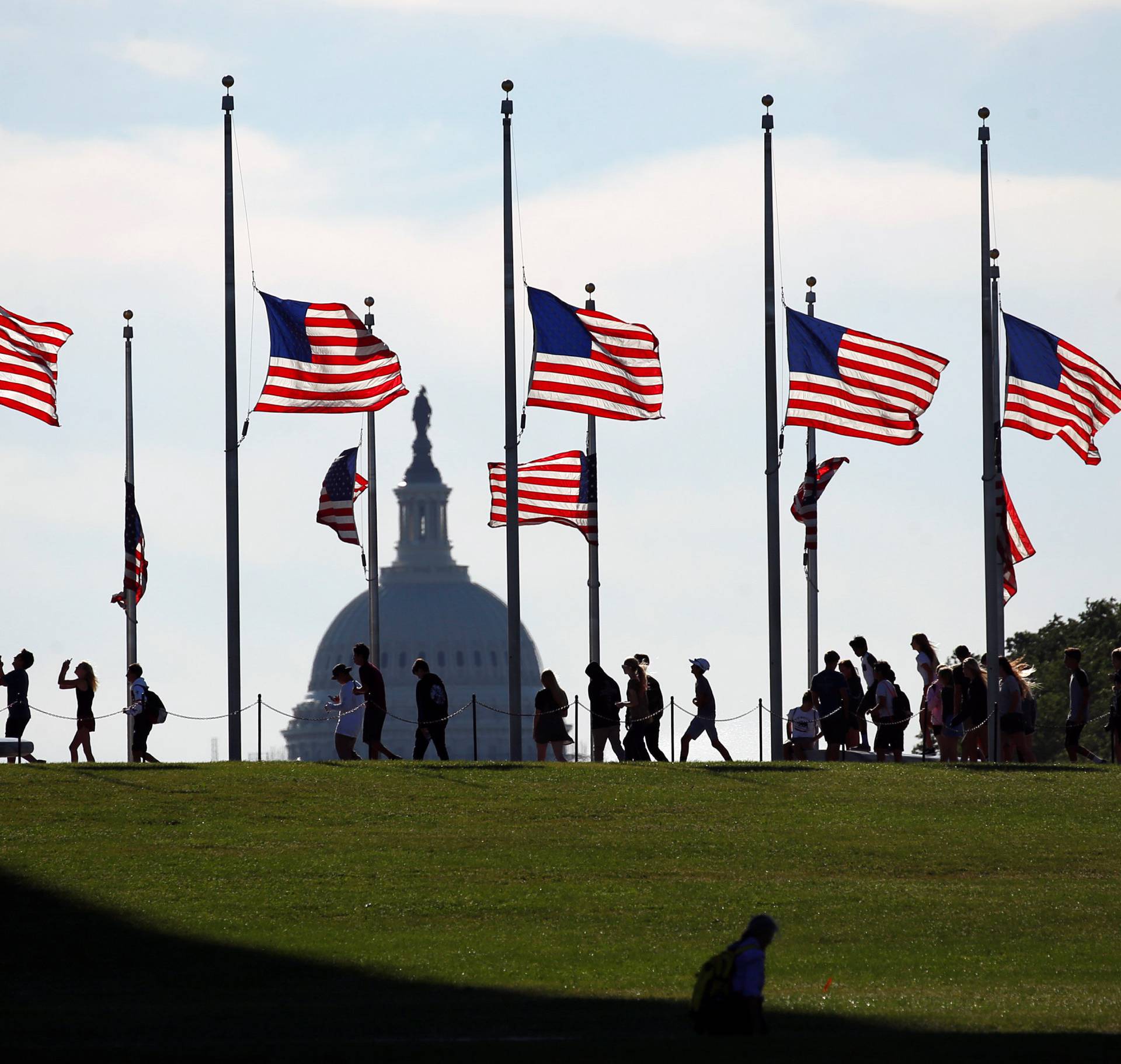 Flags at the Washington Monument fly at half staff to honor those killed in last weekend's shootings at a gay club in Orlando, Florida, in Washington