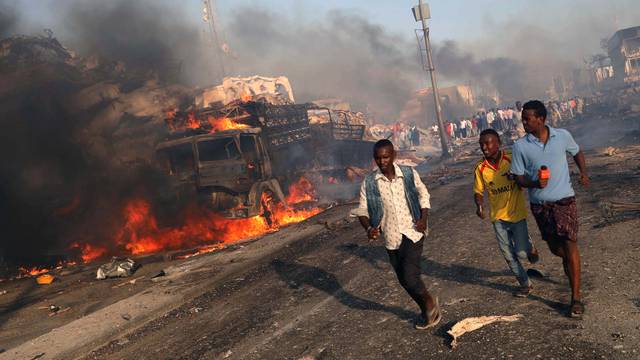 Civilians evacuate from the scene of explosion in Mogadishu