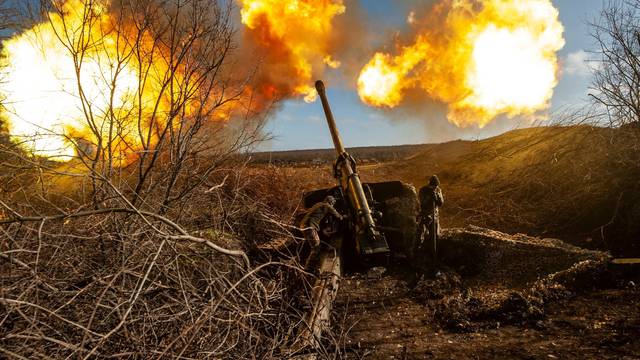 Ukrainian servicemen fire a 130 mm towed field gun M-46 on a front line near Soledar