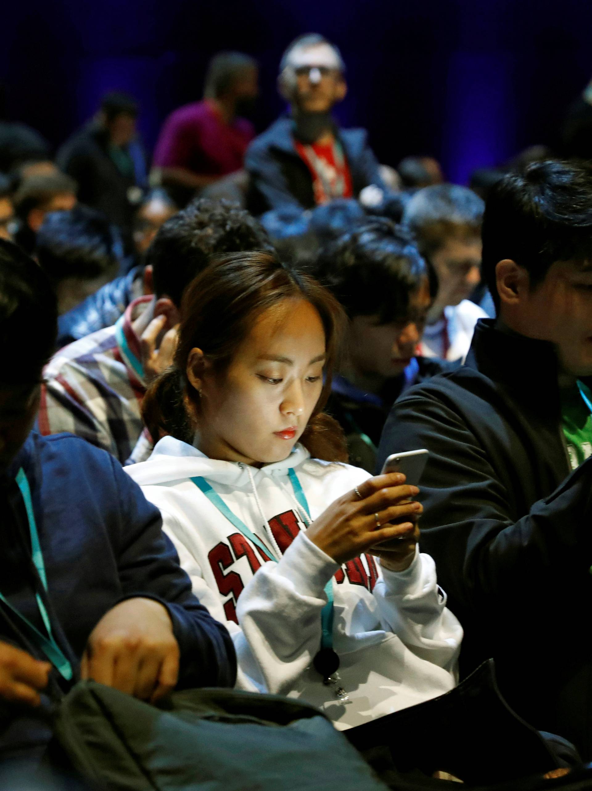 Attendees work on their devices before Apple Inc.'s 2016 Worldwide Developers Conference in San Francisco, California