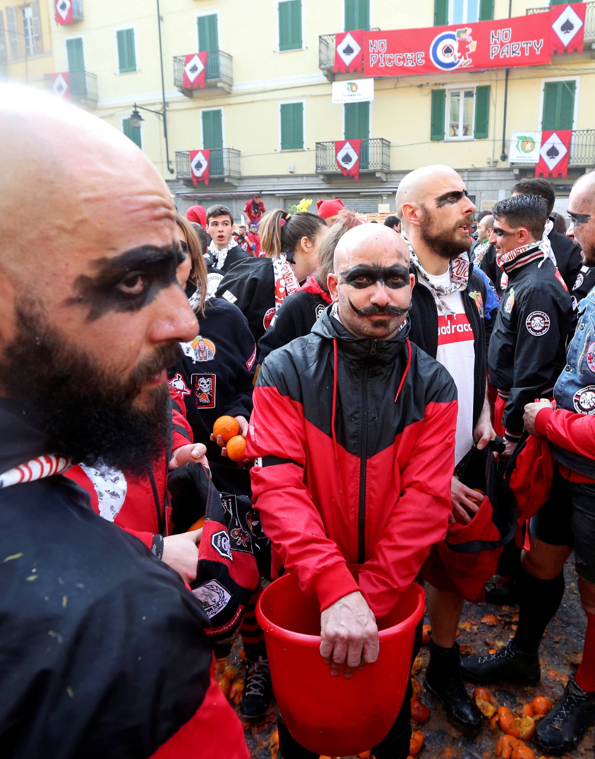 Members of a team prepare to fight with oranges during an annual carnival battle in the northern Italian town of Ivrea