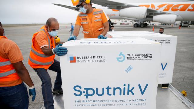 FILE PHOTO: Workers take care of the shipment of Russia's Sputnik V vaccine at the airport, in Caracas