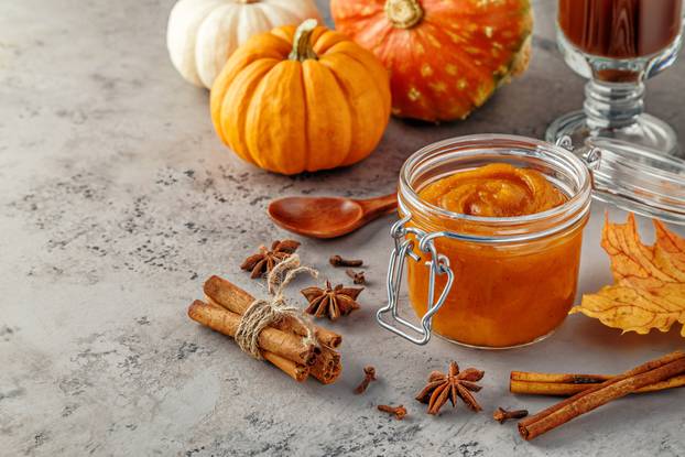 Pumpkin butter on concrete background.