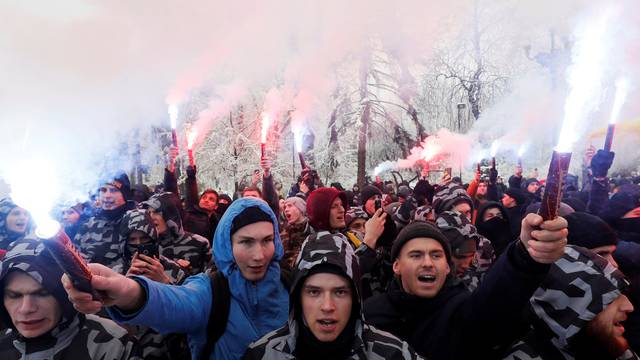 Activists of far-right parties burn flares during a rally to support the Ukrainian navy after Russia seized two Ukrainian armored artillery vessels and a tug boat in the Black Sea, in front of the presidential administration headquarters in Kiev