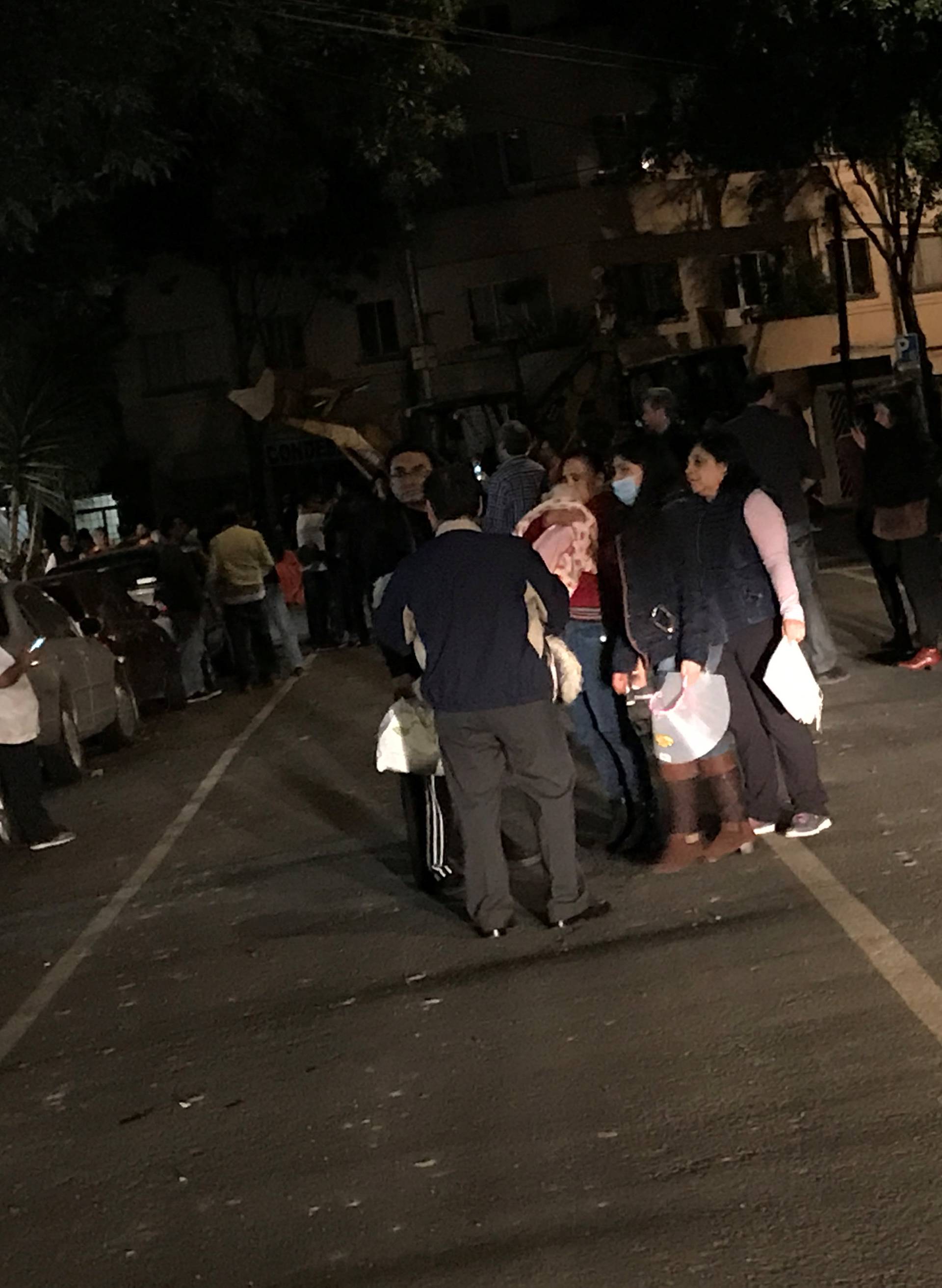 People gather on a street after an earthquake hit Mexico City