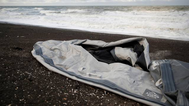 A damaged inflatable dinghy is seen on Loon Beach in Dunkerque after migrant tragedy