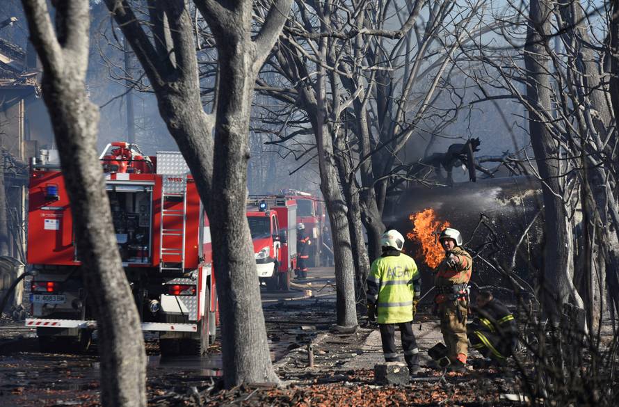 Firefighters work on the site where a cargo train derailed and exploded in the village of Hitrino