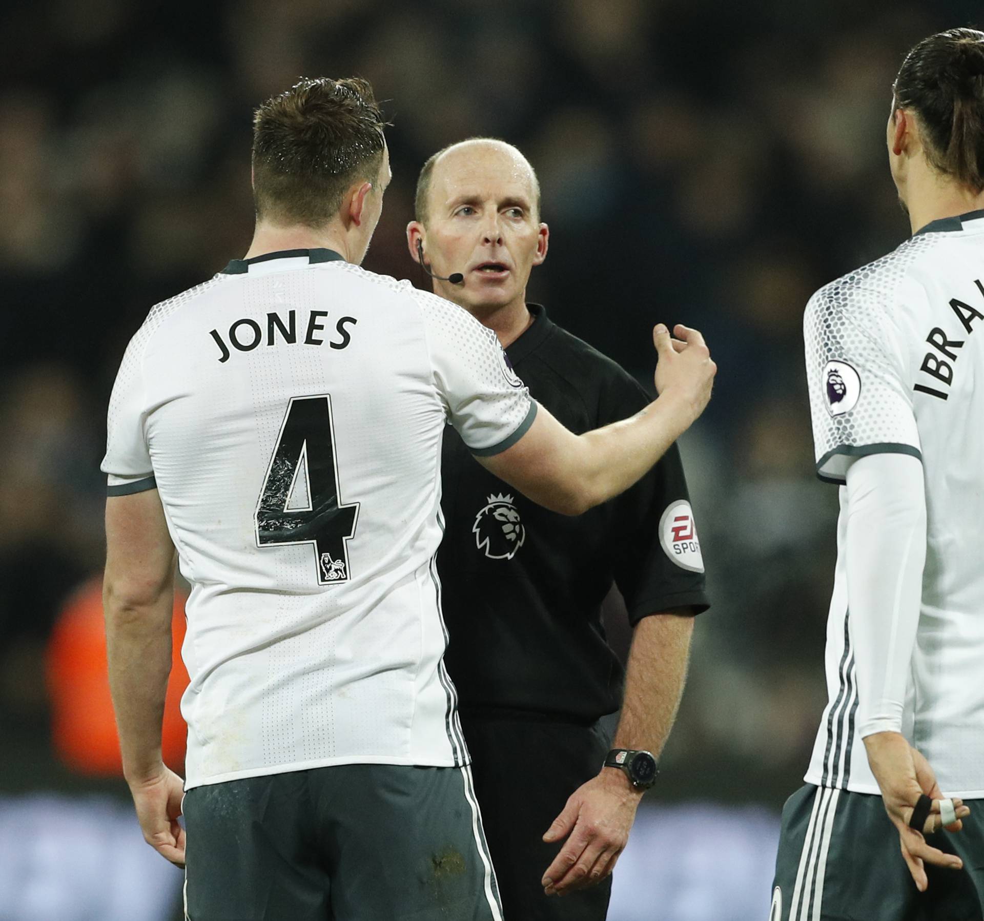 Manchester United's Phil Jones and Zlatan Ibrahimovic speak to referee Mike Dean