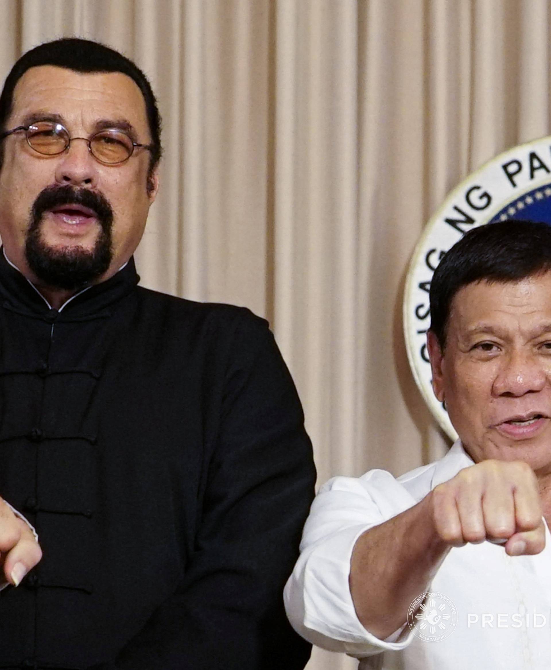 President Rodrigo Duterte with visiting American actor Steven Seagal (L) gestures during his courtesy call at the Malacanang presidential palace in Manila