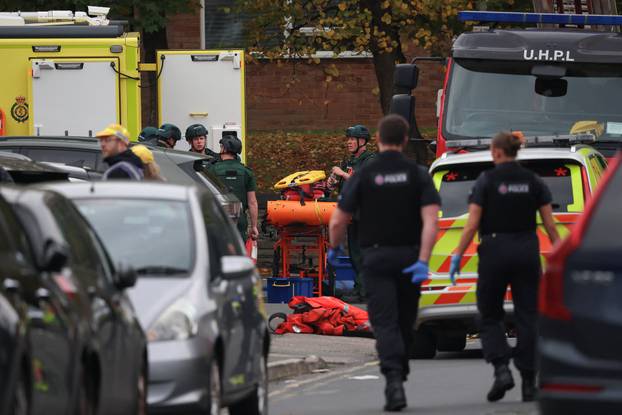 Police officers work at the scene following an incident outside a synagogue, in Manchester
