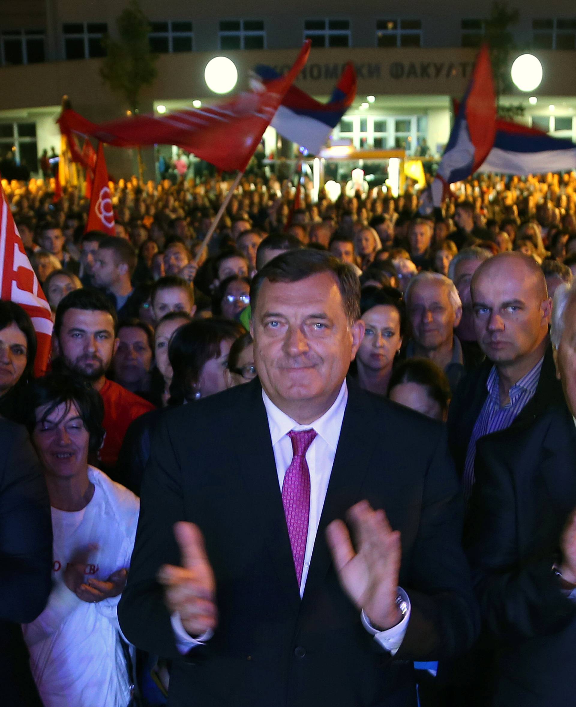Dodik celebrates the results of a referendum over a disputed national holiday during an election rally in Pale