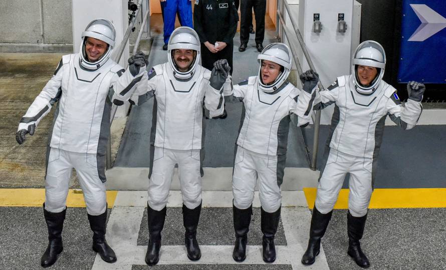 FILE PHOTO: NASA's SpaceX Crew-12 crew members walk out of the Operations & Checkout Building at the Kennedy Space Center before transport to Launch Complex 40 in Cape Canaveral