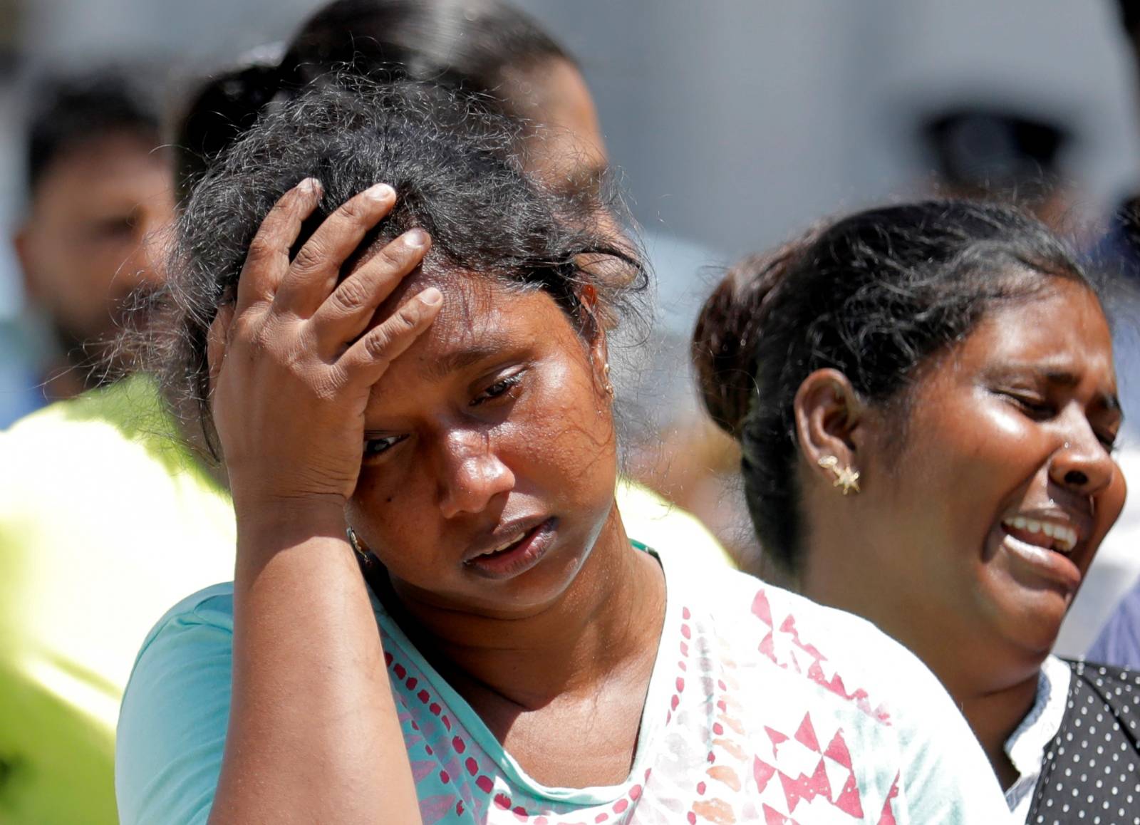 Relatives of victims react at a police mortuary following bomb blasts in Colombo