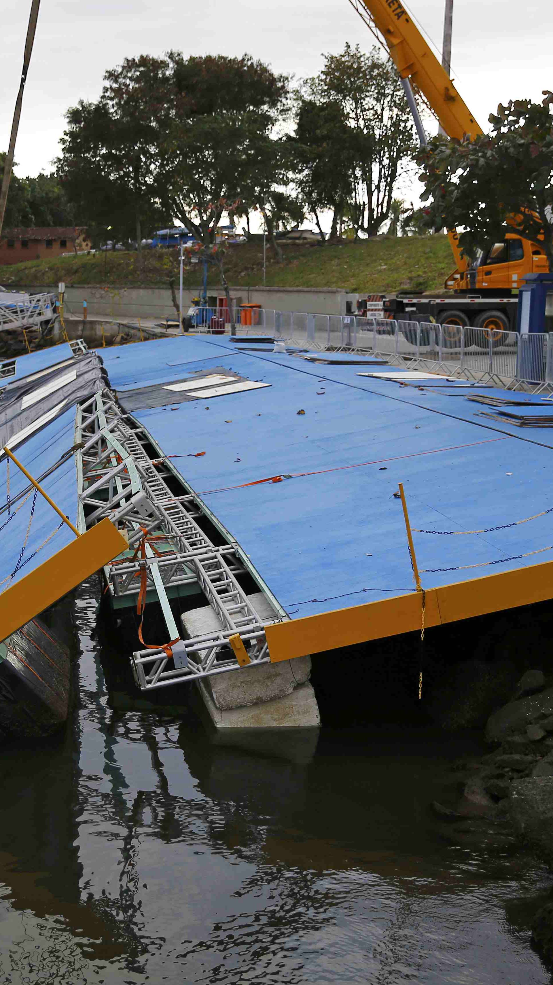 A ramp built for competitors' boats to reach the water hangs after collapsing at the Marina da Gloria in Rio de Janeiro