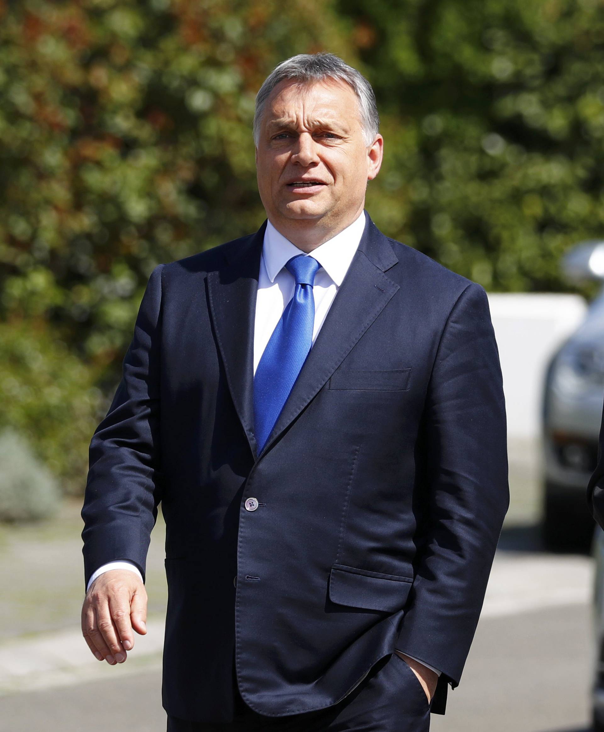 Hungarian Prime Minister Orban walks to speak to media after visiting former German Chancellor Helmut Kohl in Oggersheim