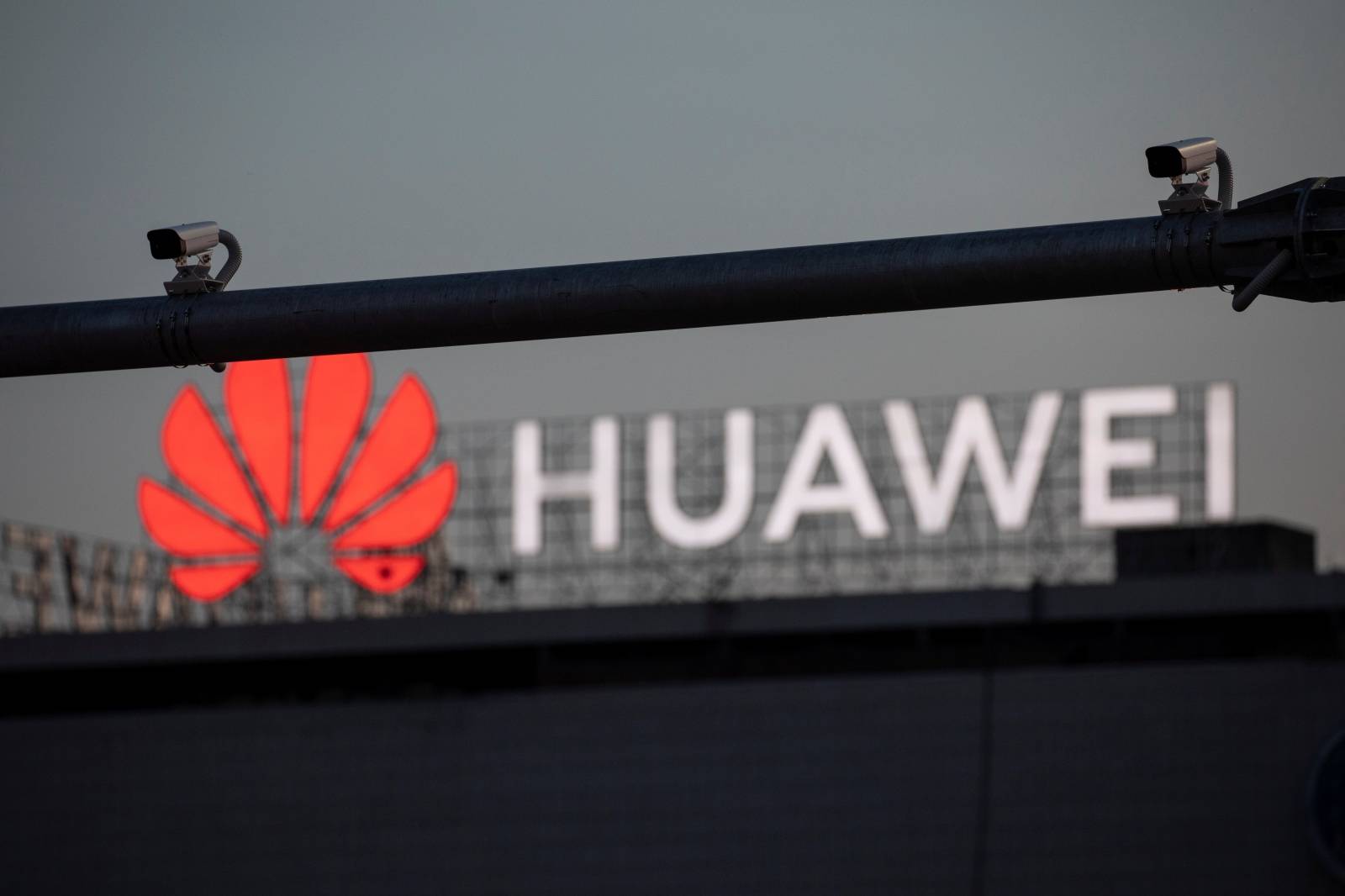 Surveillance cameras are seen in front of a Huawei logo in Belgrade