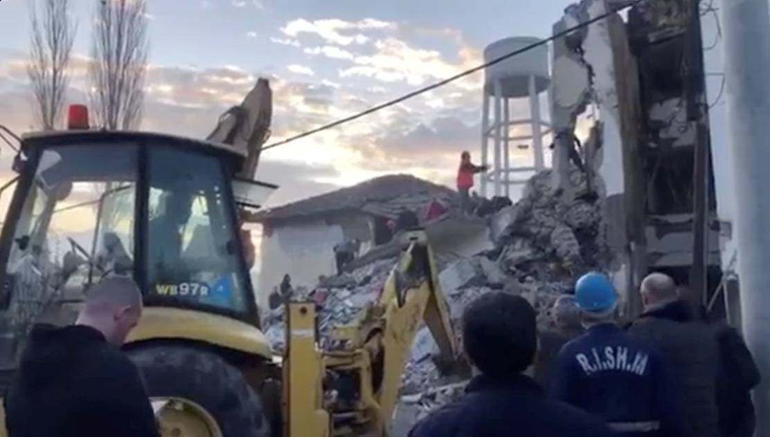 Emergency personnel and locals remove debris from damaged buildings after an earthquake in Thumane, Albania