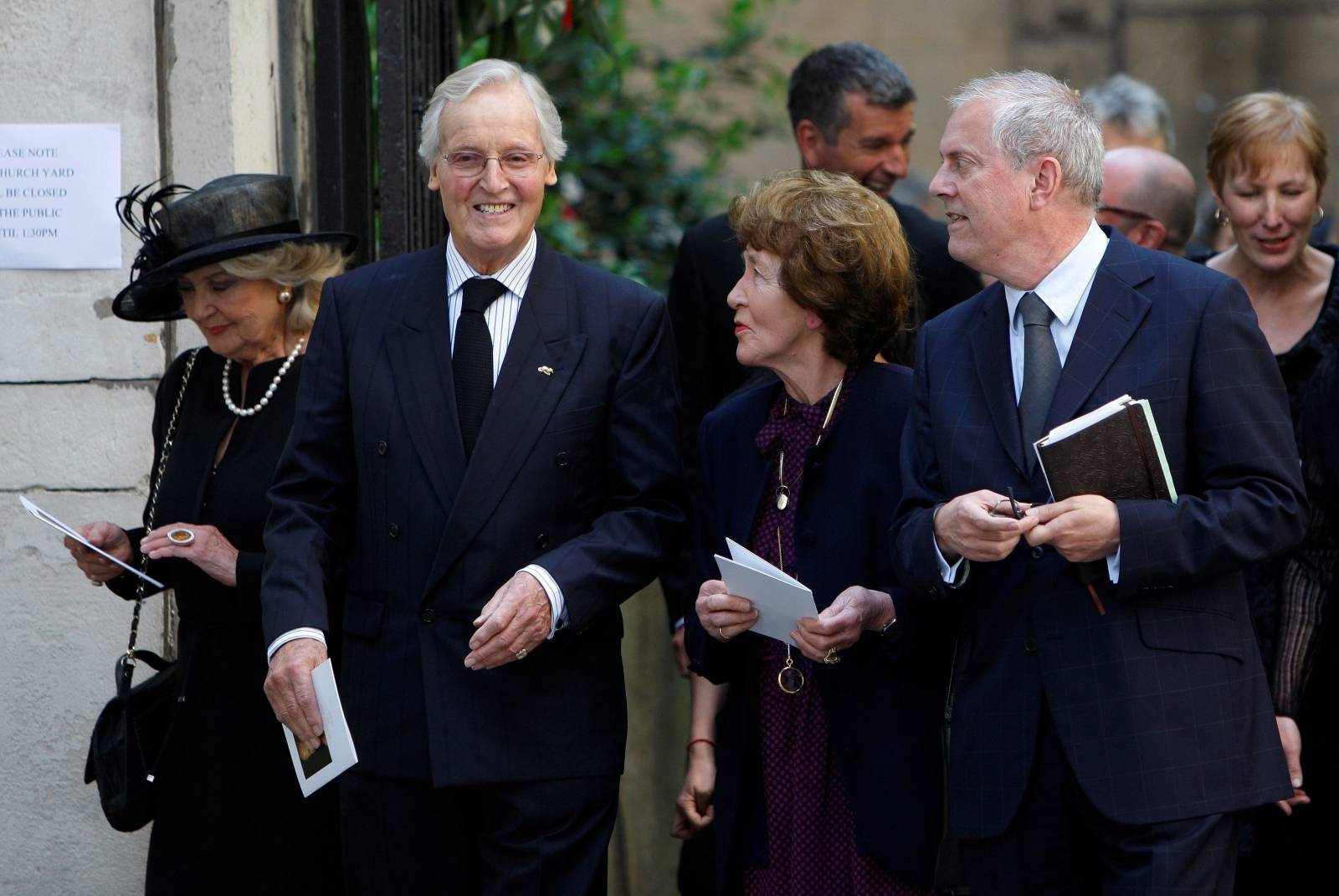 FILE PHOTO: British entertainers Nicholas Parsons and Gyles Brandreth leave the funeral of Clement Freud at St Bride's church in London