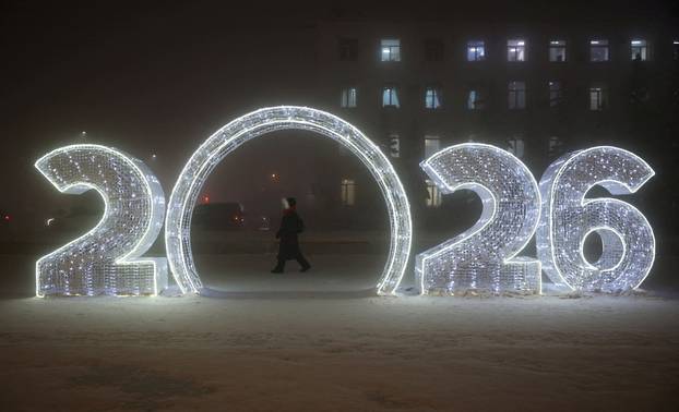 A person walks past New Year decorations on a frosty day in Yakutsk
