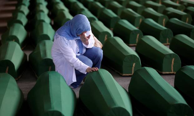 A Muslim woman cries near the coffin of her relatives, who are newly identified victims of the 1995 Srebrenica massacre and lined up for a joint burial in Potocari near Srebrenica, Bosnia and Herzegovina