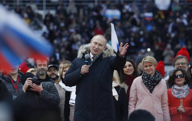 Russian President Putin delivers a speech during a rally to support his bid in the upcoming presidential election at Luzhniki Stadium in Moscow