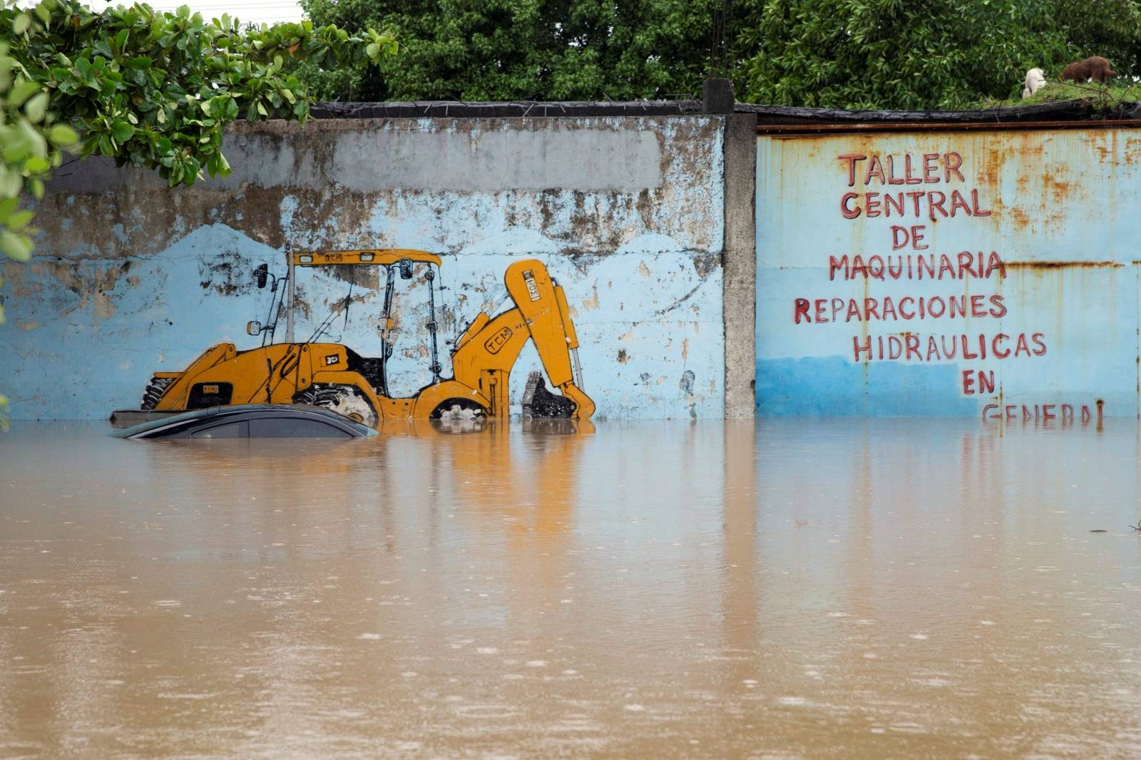 Submerged car is pictured outside a garage at an area flooded by Chamelecon river after the passing of Storm Iota, in La Lima