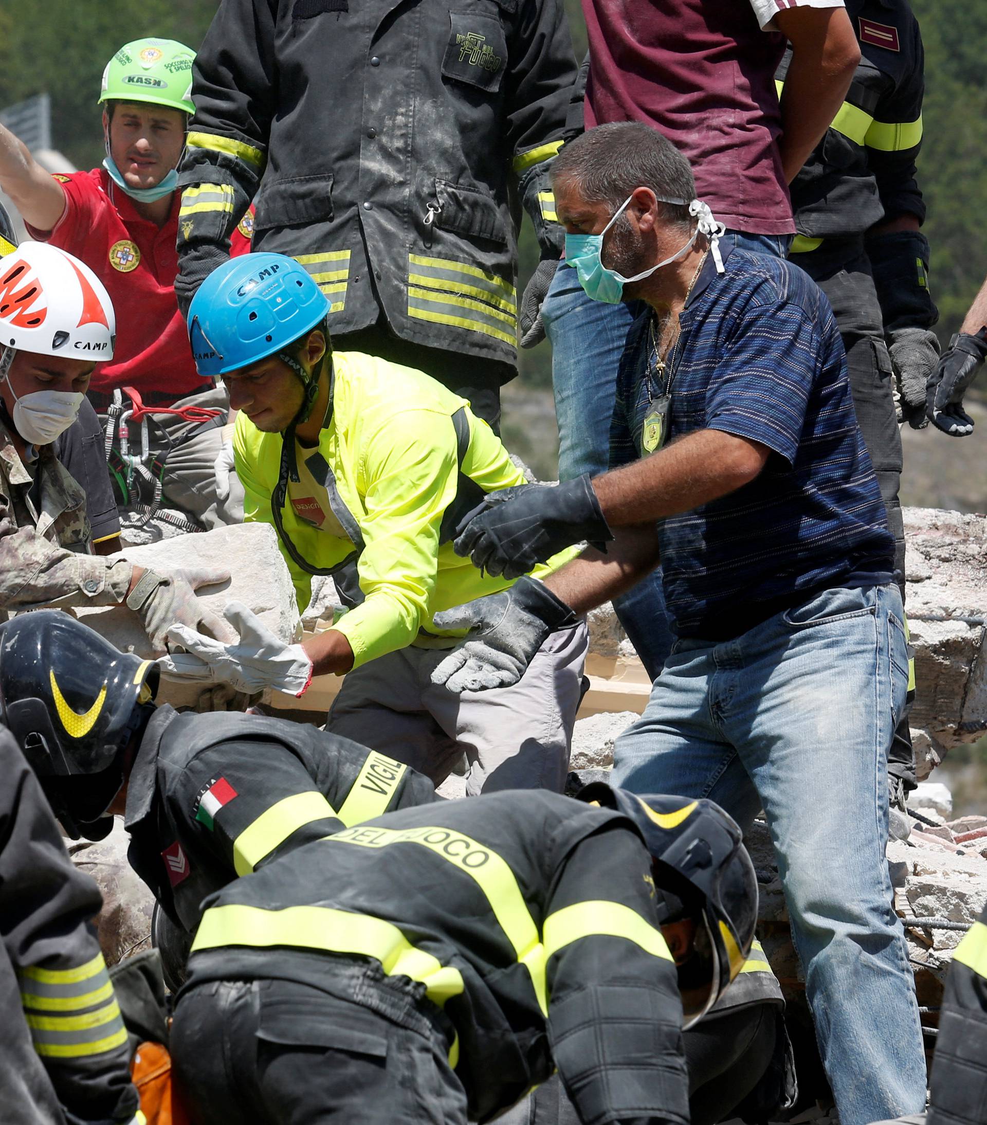 Rescuers work following an earthquake at Pescara del Tronto