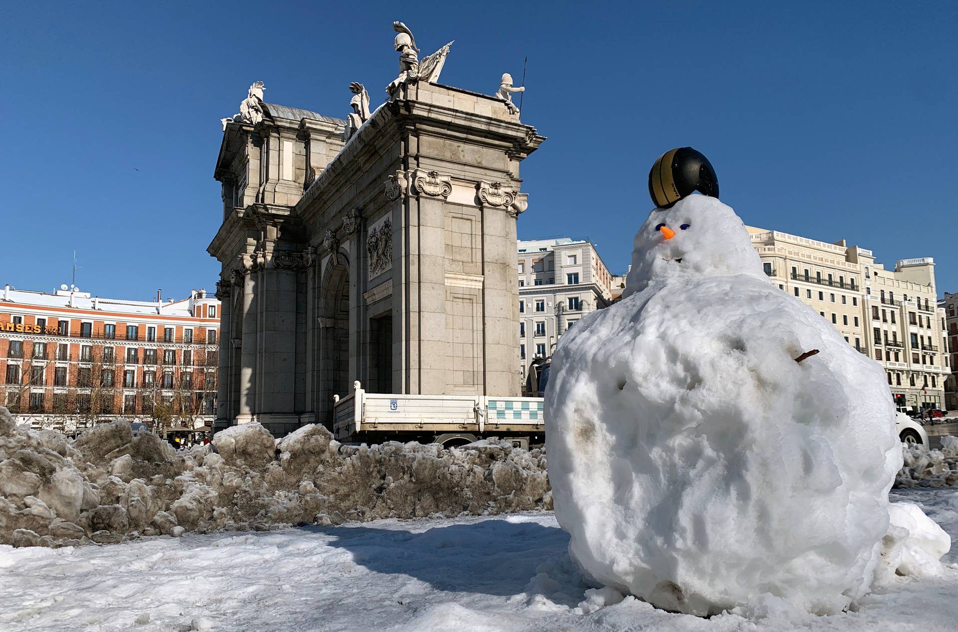 Snowman with a helmet is seen in front of the Puerta de Alcala monument, after heavy snowfal in Madrid