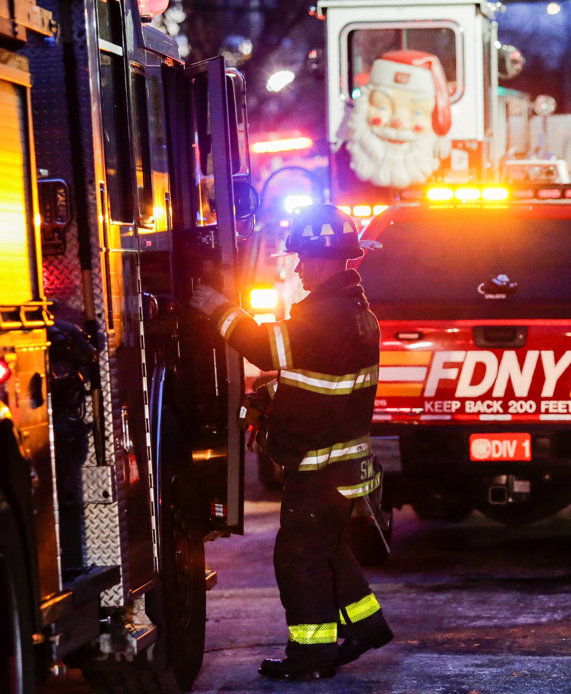 Fire Department of New York (FDNY) personnel work on the scene of an apartment fire in Bronx in New York