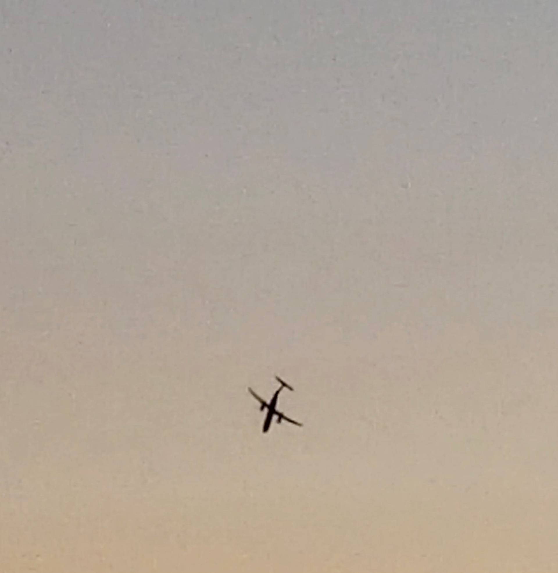 A Horizon Air Bombardier Dash 8 Q400, reported to be hijacked, flies over University Place in this still image taken from a video obtained from social media