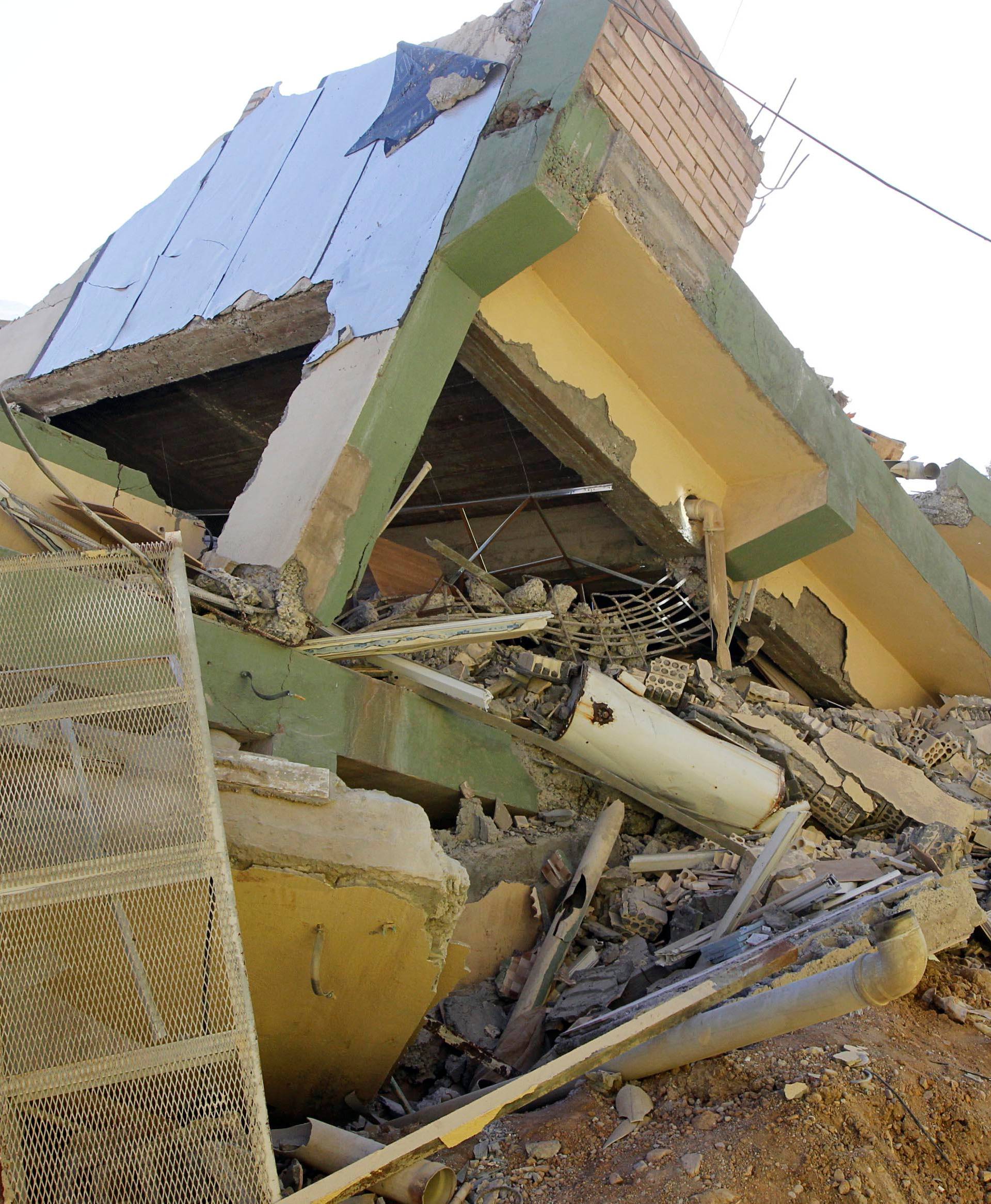 Collapsed building is seen in the town of Darbandikhan