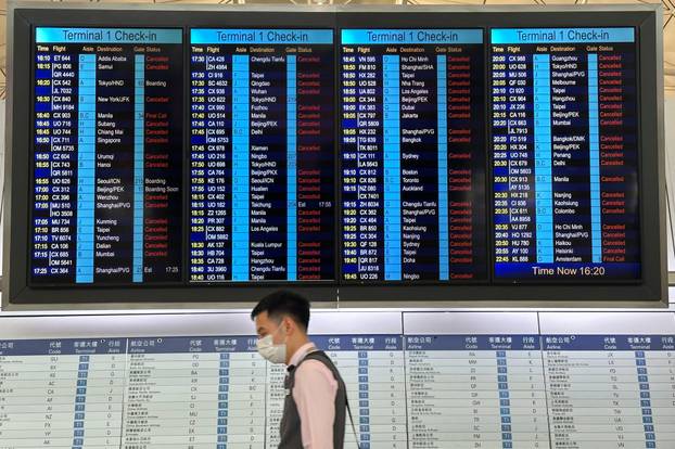 A departure board displays flight cancellations at Hong Kong International Airport as Super Typhoon Ragasa disrupts travel
