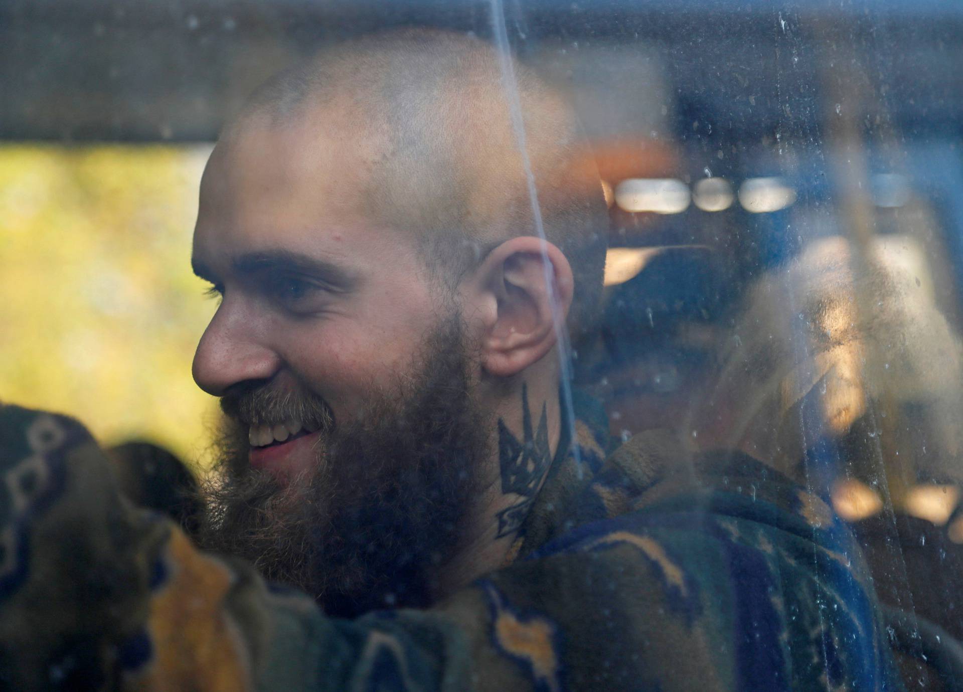 Buses carrying service members of Ukrainian forces who have surrendered after weeks holed up at Azovstal steel works arrive in Olenivka