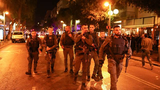 Israeli security personnel work at the scene of a shooting attack in central Tel Aviv