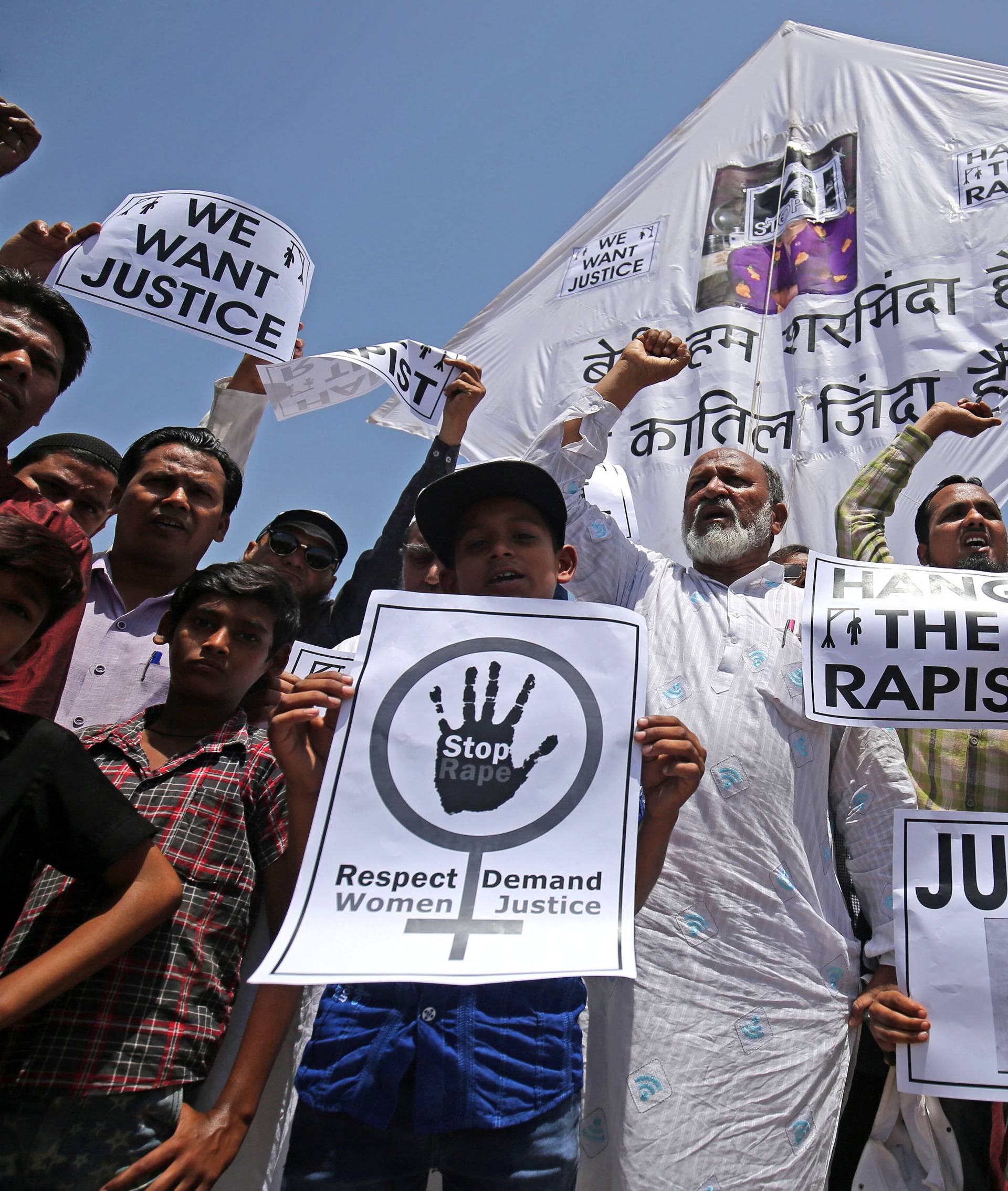 People hold placards at a protest against the rape of an eight-year-old girl, in Kathua, near Jammu, a teenager in Unnao, Uttar Pradesh state, and an eleven-year-old girl in Surat, in Ahmedabad