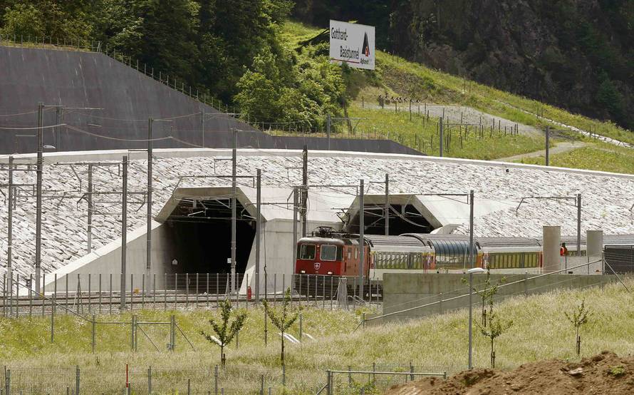 A train drives past the northern gates of the NEAT Gotthard Base Tunnel near Erstfeld