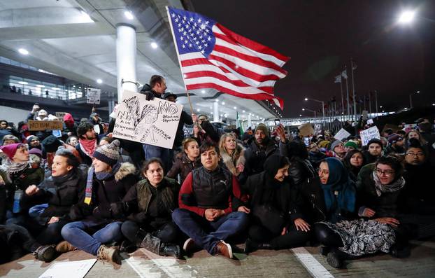 People gather to protest against the travel ban imposed by U.S. President Donald Trump