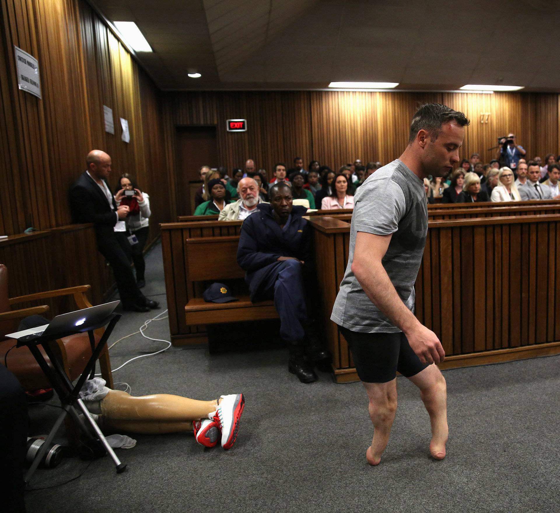 Paralympic gold medalist Oscar Pistorius walks across the courtroom without his prosthetic legs during the third day of the resentencing hearing for the 2013 murder of his girlfriend Reeva Steenkamp, at Pretoria High Court