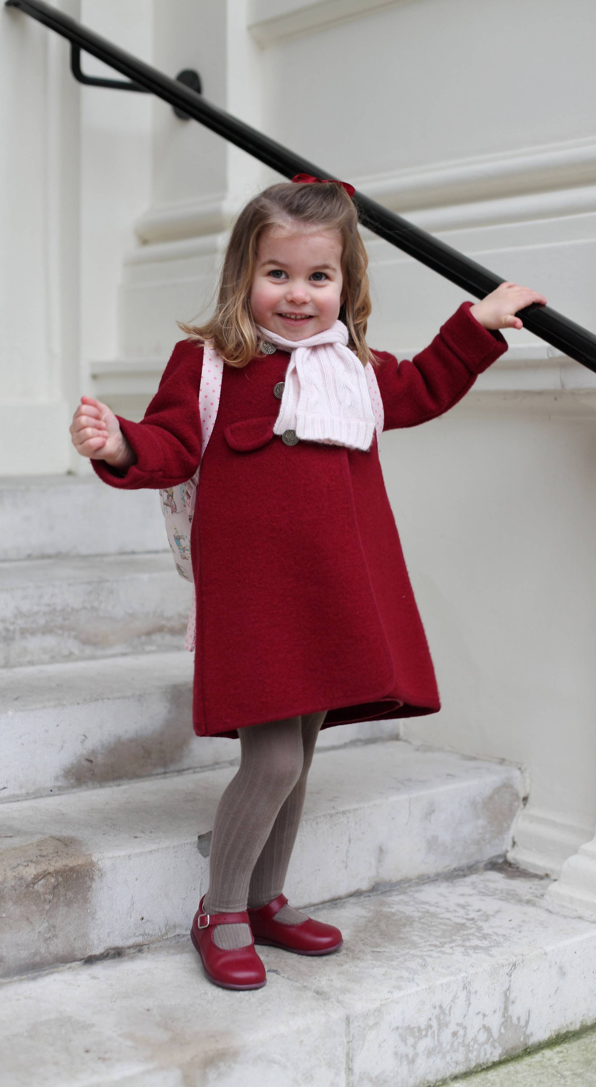 Britain's Princess Charlotte stands on the steps at Kensington Palace in a photograph taken taken by her mother and handed out by Britain's Prince William and Catherine, the Duchess of Cambridge