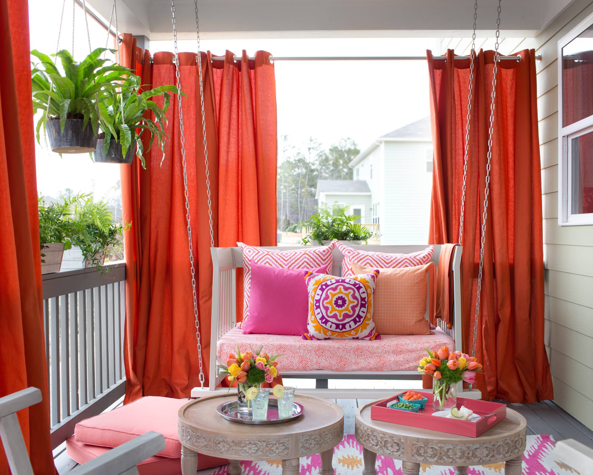 Vibrant Outdoor Space With Hanging Daybed and Draperies